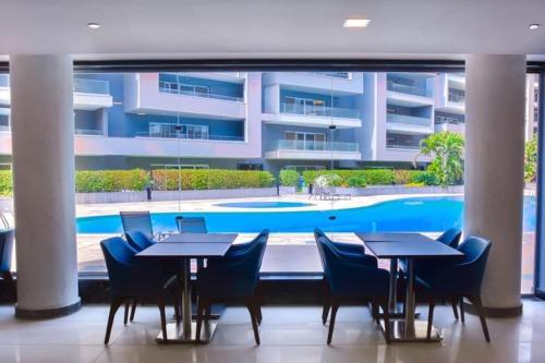 a restaurant with tables and chairs in front of a building at Serviced apartment -Sheraton Al Matar (Ocean blue) in Cairo