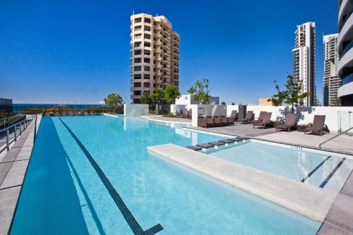 a swimming pool on the roof of a building at Oracle Resort - Q Stay in Gold Coast
