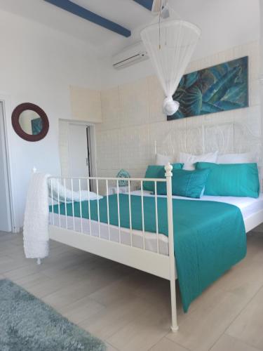 a bedroom with a bed with blue and white at Παραθαλάσσιο Σπίτι θαλάσσια Αυρα in Nafplio