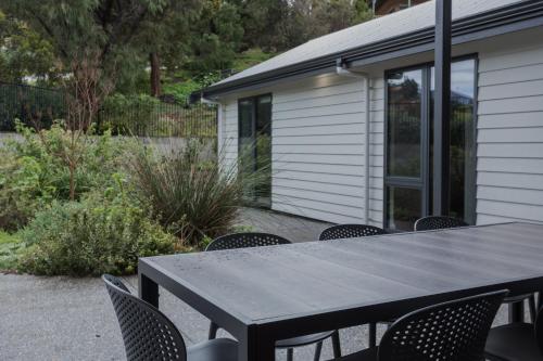 a black table and chairs on a patio at Vancouver's End by the BnB Collection in Albany