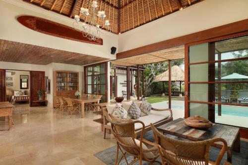 a living room with a couch and a table at Jimbaran Beach Villas by Nakula in Jimbaran