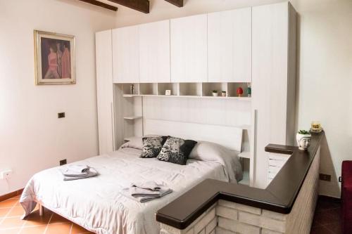 a small bedroom with a bed and a staircase at Casa Vacanze da Angela in Alghero