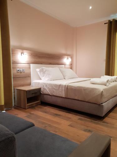 a bedroom with a large bed and a couch at Mondeus Inn Luxury in Deskáti