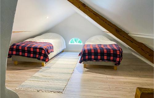 Finspång的住宿－1 Bedroom Stunning Home In Tjllmo，阁楼设有两张床,设有楼梯。