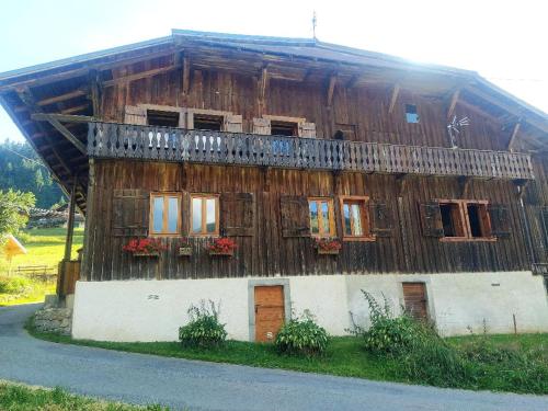 a wooden house with windows and a balcony at Chalet Lisa in Morzine