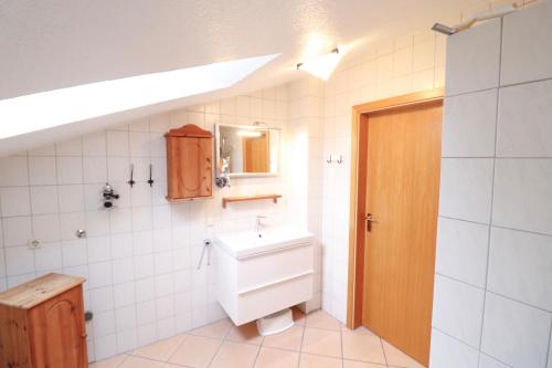 a bathroom with a toilet and a sink in it at Bauernhof FeWo IV Waldblick in Schwienkuhl an der Ostsee in Schwienkuhl