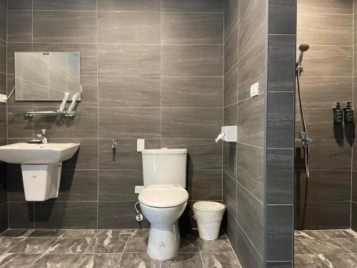 a bathroom with a toilet and a sink at H Suite Sea in Lukang