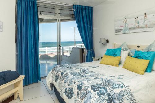 a bedroom with a bed and a view of the ocean at LA CRETE SANDS NO 1 in Margate