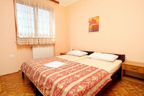 a bedroom with two beds and a window at Apartments with parking space Umag - 7109 in Umag