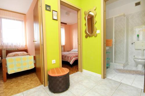 a room with a bathroom with a toilet and a bedroom at Apartments with parking space Umag - 7109 in Umag