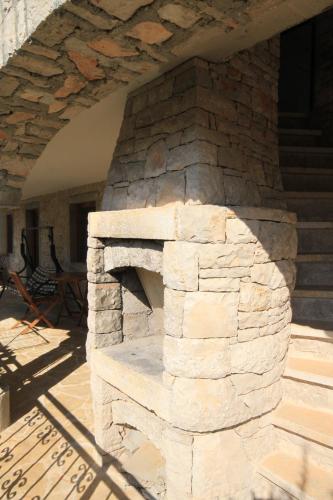 a stone brick oven in a patio with stairs at Studio Basanija 7148a in Savudrija