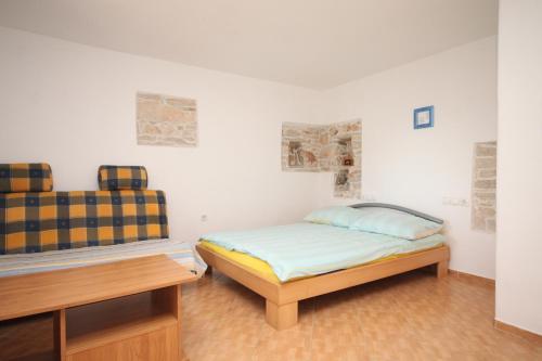 a bedroom with two beds in a room with white walls at Studio Basanija 7148a in Savudrija