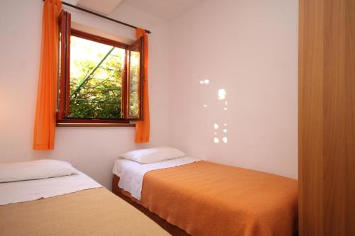 a bedroom with two beds and a window at Apartments with parking space Fazana - 7153 in Fažana