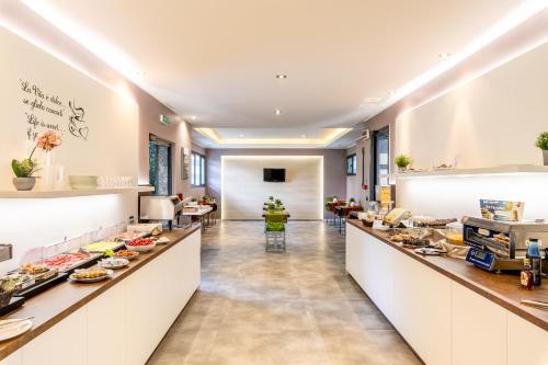 a restaurant with a buffet line with food at Acca Palace AA Hotels in Milan