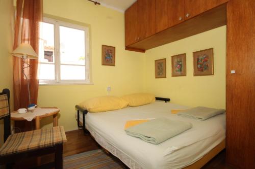 a bedroom with a bed with two pillows on it at Apartments with a parking space Rovinj - 7145 in Rovinj