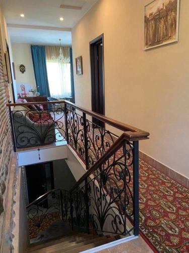 a staircase in a home with a stair railing at Dzveli Ubani in Sighnaghi