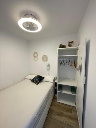 mały pokój z 2 łóżkami i lodówką w obiekcie Apartamento vistas al Mar Aire acondicionado Wifi w mieście Empuriabrava