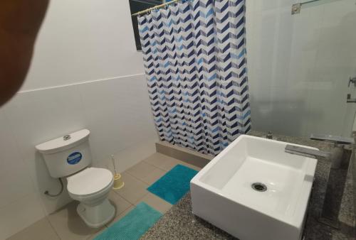 a bathroom with a white sink and a toilet at La Casona Hospedaje in Lima