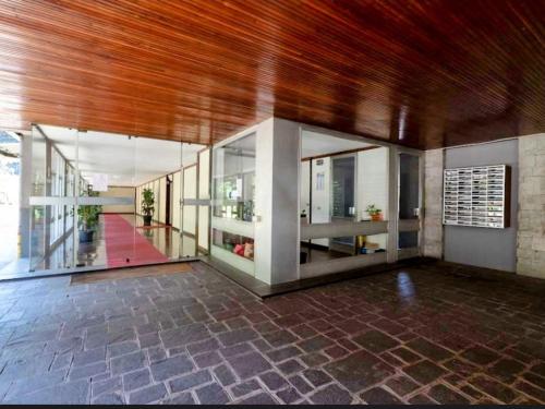 a large room with a brick floor and wooden ceiling at Short Rent Milan Porta Vittoria in Milan