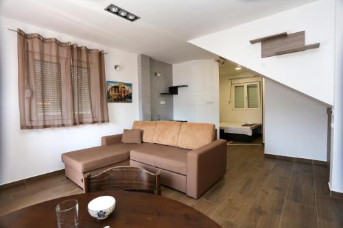 a living room with a couch and a table at Magnolija apartmani in Igalo