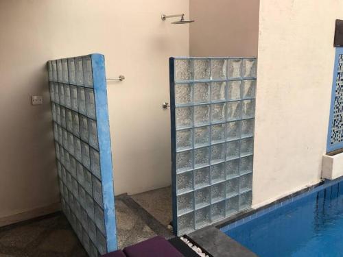 a swimming pool with glass dividers next to a swimming pool at 5 Bedroom Holiday Villa - Kuta Regency B8 in Kuta