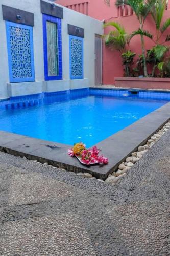 a swimming pool with a bowl of flowers next to it at 5 Bedroom Holiday Villa - Kuta Regency B8 in Kuta