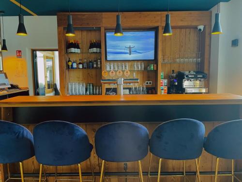 a bar with blue stools in a restaurant at Hotel La Verticale in Chamonix