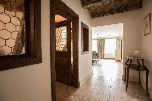 a hallway with a wooden door and a tile floor at Hotel Nerudova 211 in Prague