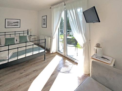 a bedroom with two beds and a sliding glass door at Willa Liliowa in Dębki