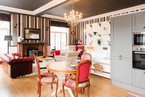 a living room with a table and chairs at The Merryburn - Rooms and Courtyard Studios in Dunkeld