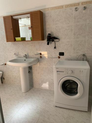 a bathroom with a washing machine and a sink at Casa Anter Santa Maria di Leuca in Leuca