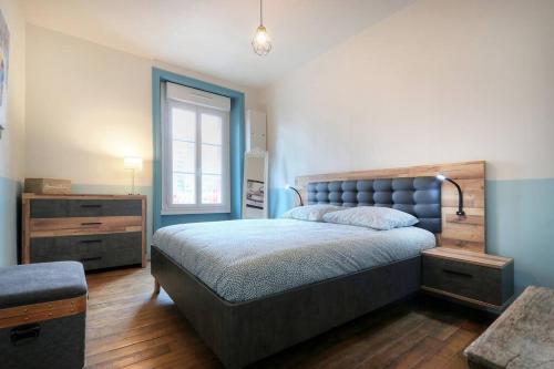 a bedroom with a large bed and a window at Le Beaumont in Rennes
