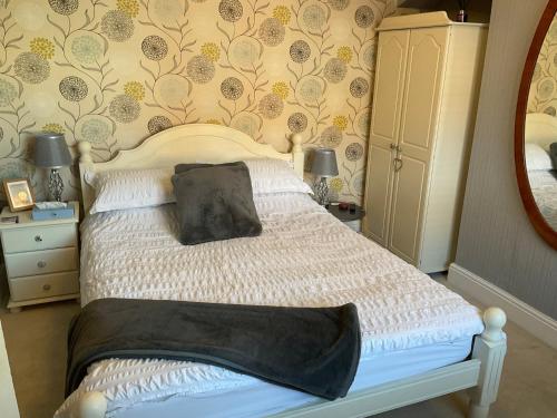 a bedroom with a bed with a black pillow on it at Park View in Chester