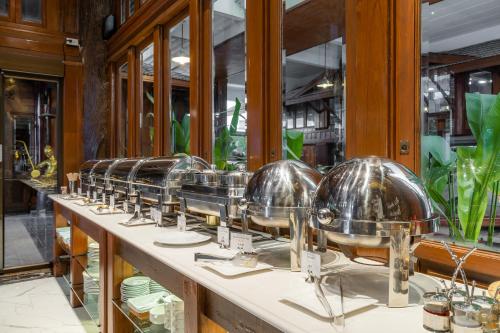 a row of glass bowls on a counter at True Siam Phayathai Hotel in Bangkok