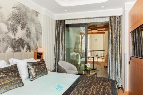 a hotel room with a bed and a balcony at Mukarnas Pera Hotel in Istanbul
