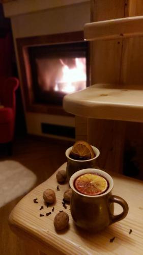 a table with a cup of coffee and some cookies at Słoneczna Chata z Bali in Lądek-Zdrój