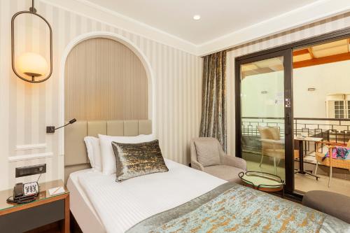 a hotel room with a bed and a chair at Mukarnas Pera Hotel in Istanbul