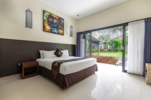 a bedroom with a bed and a large window at Full Moon Villa Ubud in Ubud