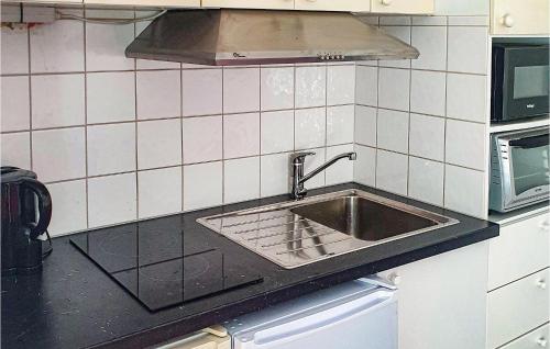 a kitchen with a sink and a microwave at Stunning Home In Motala With Wifi in Motala