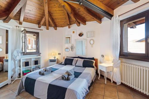 Un dormitorio con una cama grande con dos animales de peluche. en La Casa di Annibale, en Massino Visconti