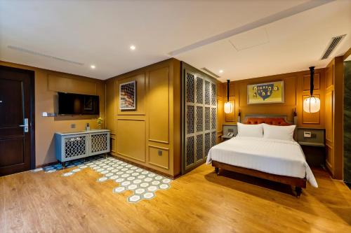 a bedroom with a bed and a tv in it at Son Hoi An Boutique Hotel & Spa in Hoi An