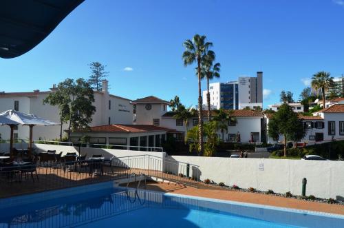 a view of a swimming pool with buildings at Madeira Bright Star by Petit Hotels in Funchal