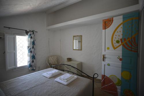 a bedroom with a bed and a window at Kite Hostel Stagnone in Marsala