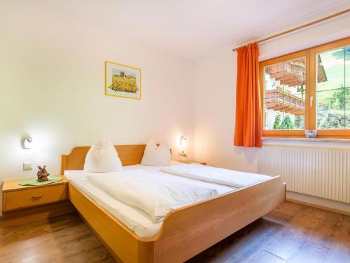 a bedroom with a bed and a window at Group Apartment in Stubaital with Ski Storage in Neustift im Stubaital