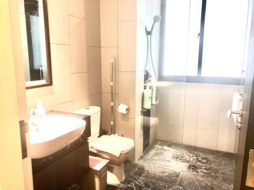 a bathroom with a toilet and a sink and a shower at The Landmark Seaview Netflix By Blue Sky Holidays in George Town