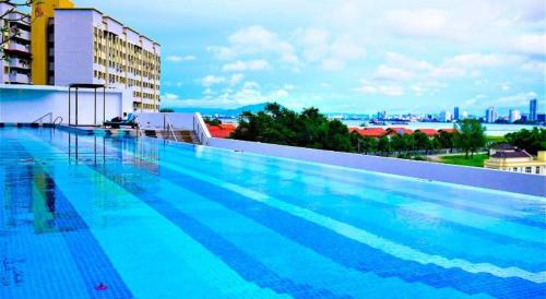 a large swimming pool on top of a building at The Landmark Seaview Netflix By Blue Sky Holidays in George Town