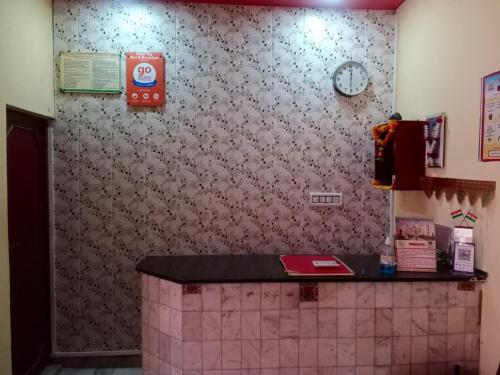 a kitchen with a counter and a clock on a wall at Hotel Raj in Agra