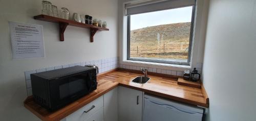 una pequeña cocina con TV y ventana en Boujee, en Lake Tekapo