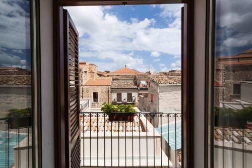 a view of a balcony from a window at Guascone Apartments in Palermo