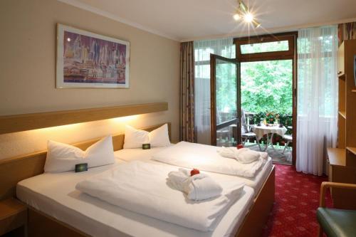 a hotel room with a bed with towels on it at AktiVital Hotel in Bad Griesbach